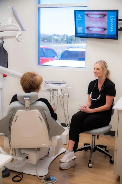 Dr. Klassen speaking to a female cosmetic dentistry patient